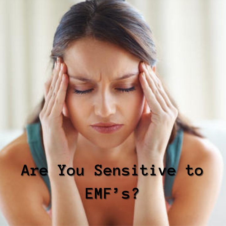 woman with hands on her head, eyes closed, fingers to temples as if she has a headache. The title on the photo says are you sensitive to EMF's?